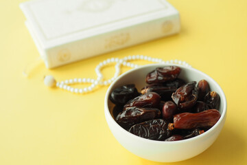 date fruit and Holy Quran on table 