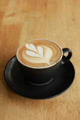 a cup of late coffee with flower shape design on top at cafe 