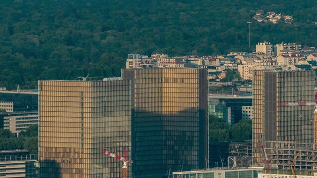 Top view of Paris skyline with National Library of France from above timelapse. Main landmarks of european megapolis at sunset. Bird-eye view from observation deck of Montparnasse tower. Paris, France