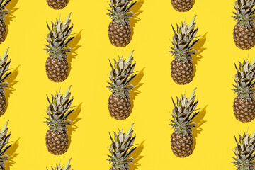 Pineapple on a yellow background. Minimal and modern design and pattern.