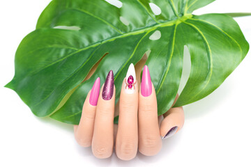 Female hand with stiletto nail design. Glitter purple nail polish manicure. Female model hand with...