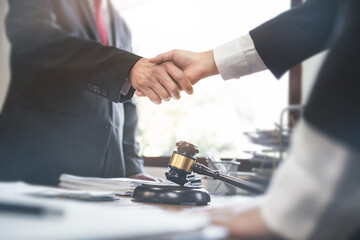 Lawyer consultant shaking hand with client in law firm..
