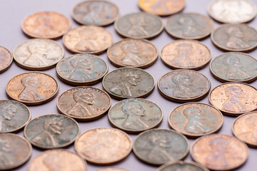 Old cent coins on purple background.