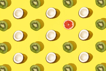 Arranged coconut, kiwi and grapefruit on a  minimal background.