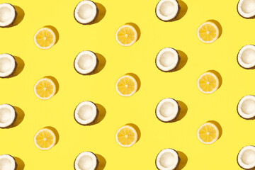 Lemon and coconut on a minimal pastel yellow background. Pattern. Modern design.