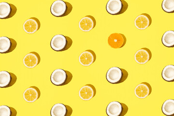 Mixed fruit coconut, lemon and tangerine on a yellow background. Pattern.