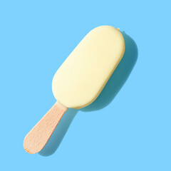 Vanilla ice cream on a stick on blue background