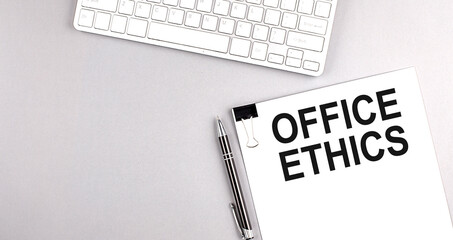 BUSINESS ETHICS text on paper with keyboard on grey background