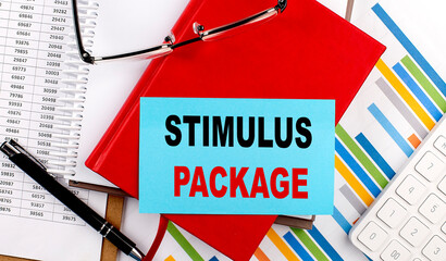 STIMULUS PACKAGE text on sticky on red notebook on chart background