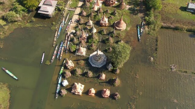 Aerial top down shot of Stupas of Taw Mwe Khaung Pagoda in Myanmar during sunny day