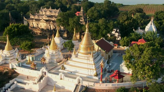 Drone panning shot of the Maha Sutaungpyae Htihlaingshin Pagoda and Me Nu Brick Monastery. Near Mandalay, Myanmar