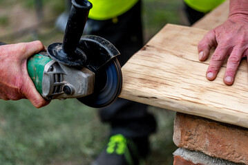 A carpenter works in a garden.
