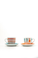 Two colorful coffee cups or mugs on white background. With copyspace