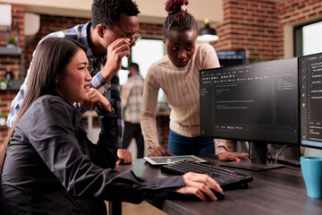 Diverse programming engineers talking about html script, looking at code on computer, working on server interface development. Tech enginners parsing cloud computing project with big data in it agency
