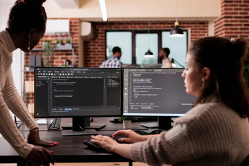 Programming engineers using computer to write code and develop algorithm program. Software developers working on user interface with html script and terminal window in development company.