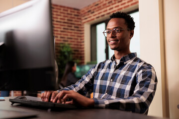 Software developer working on software program in it programming agency, utilizing skills in coding and technology to create more inclusive program. System engineer writing html script