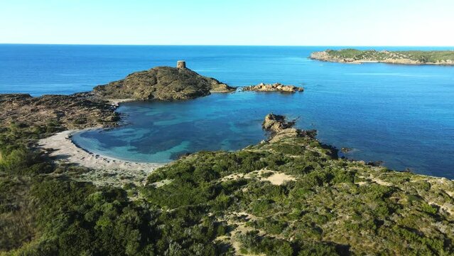 cinematic drone zooming in to small white sand beach on Menorca, Spain.