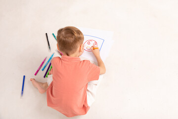 Cute child little boy drawing with pencils isolated on white. Child education. Creation. Childhood