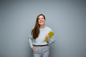 Happy young teacher woman or student girl holding book isolated portrait.
