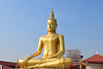 BANGKOK, THAILAND : March 29, 2023 - The Big Golden Buddha Statue with blue sky and white cloud in Buddhist temples in Bangkok, Thailand. Concept for those who have faith to come to pay respect.
