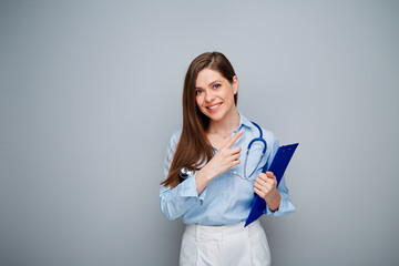 Smiling doctor woman pointing finger up,  isolated portrait with copy space.