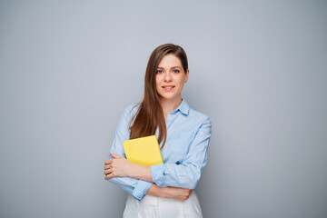 Fototapeta premium Smiling happy teacher woman or student girl with yellow book.
