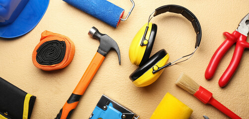 Set of carpenter's tools on beige background