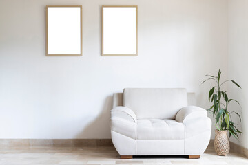 Mockup dos cuadros en pared blanca y sillón en piso de mármol