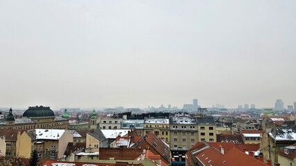 Snowy cityscape of Zagreb on an overcast day with light smog, Croatia