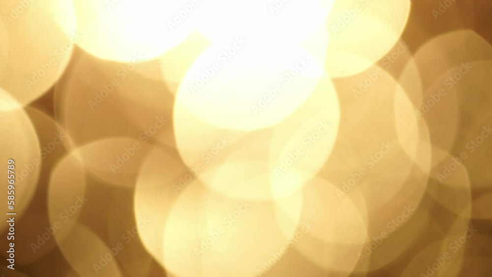 Wall mural abstract glow bokeh background in golden sepia tones. abstract shimmering movement of large defocuse