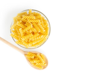 Wooden spoon with pasta isolated on white background, banner, header, template with copy space. Raw pasta fusilli, ingredient for cook, traditonal italian cuisine. Flat lay, top view