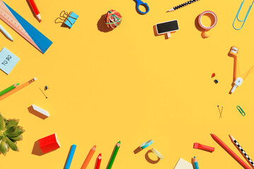 School supplies collection on pastel yellow background. Back to school flat lay.	
