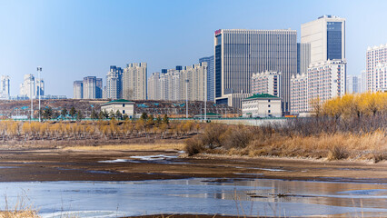 Landscape along the Yitong River in Changchun, China with melting ice and snow