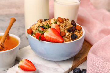 Bowl of tasty granola on table