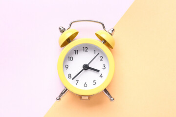 Vintage alarm clock on color background