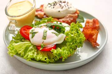 Plate with tasty egg Benedict on white table, closeup