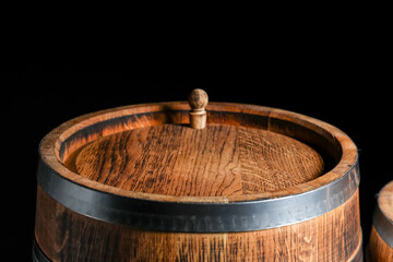 Wooden barrel on dark background, closeup