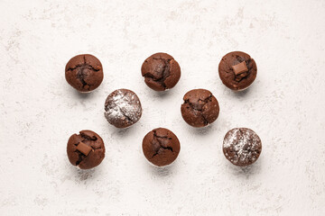 Tasty chocolate cupcakes on light background