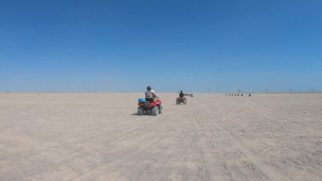 Cairo, Egypt - 13 September, 2019: Tourists riding on a quad bikes during safari in the desert near Hurghada, Egypt.