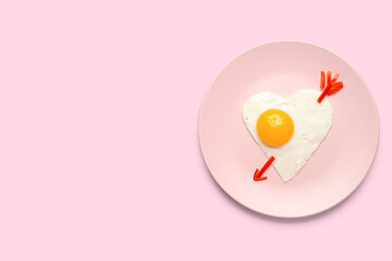 Plate with cute children's breakfast on pink background