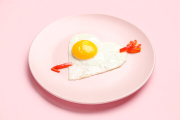 Plate with cute children's breakfast on pink background