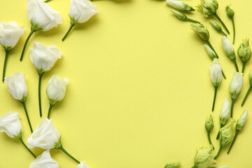 Frame made of white eustoma flowers on yellow background, closeup