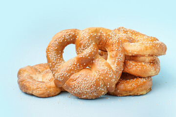 Tasty pretzels on color background