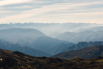 background of a landscape with many mountains at different levels separated with mist.