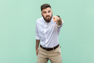 Fototapeta premium Businessman looking at camera with serious expression, pointing at you, expressing anger and hate.