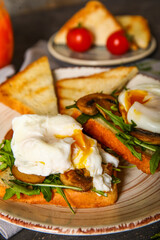 Plate with tasty eggs Benedict on table, closeup