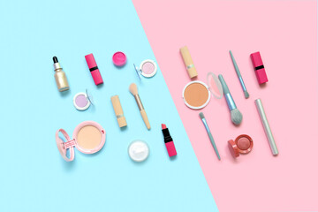 Decorative cosmetics with makeup brushes on blue and pink background