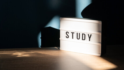 Study background concept. Study room concept. Wooden table or desk with lamp in a home with natural daylight. Comfortable workplace. Selective focus included.