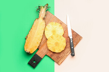 Wooden board with fresh juicy pineapple slices on color background