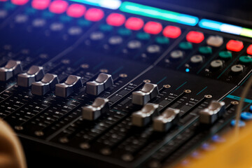 Concert sound mixer panel with volume regulators. Professional audio and light equipment for sound...